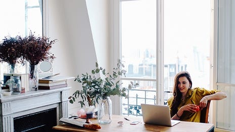 woman attending her self-paced study program from her living room