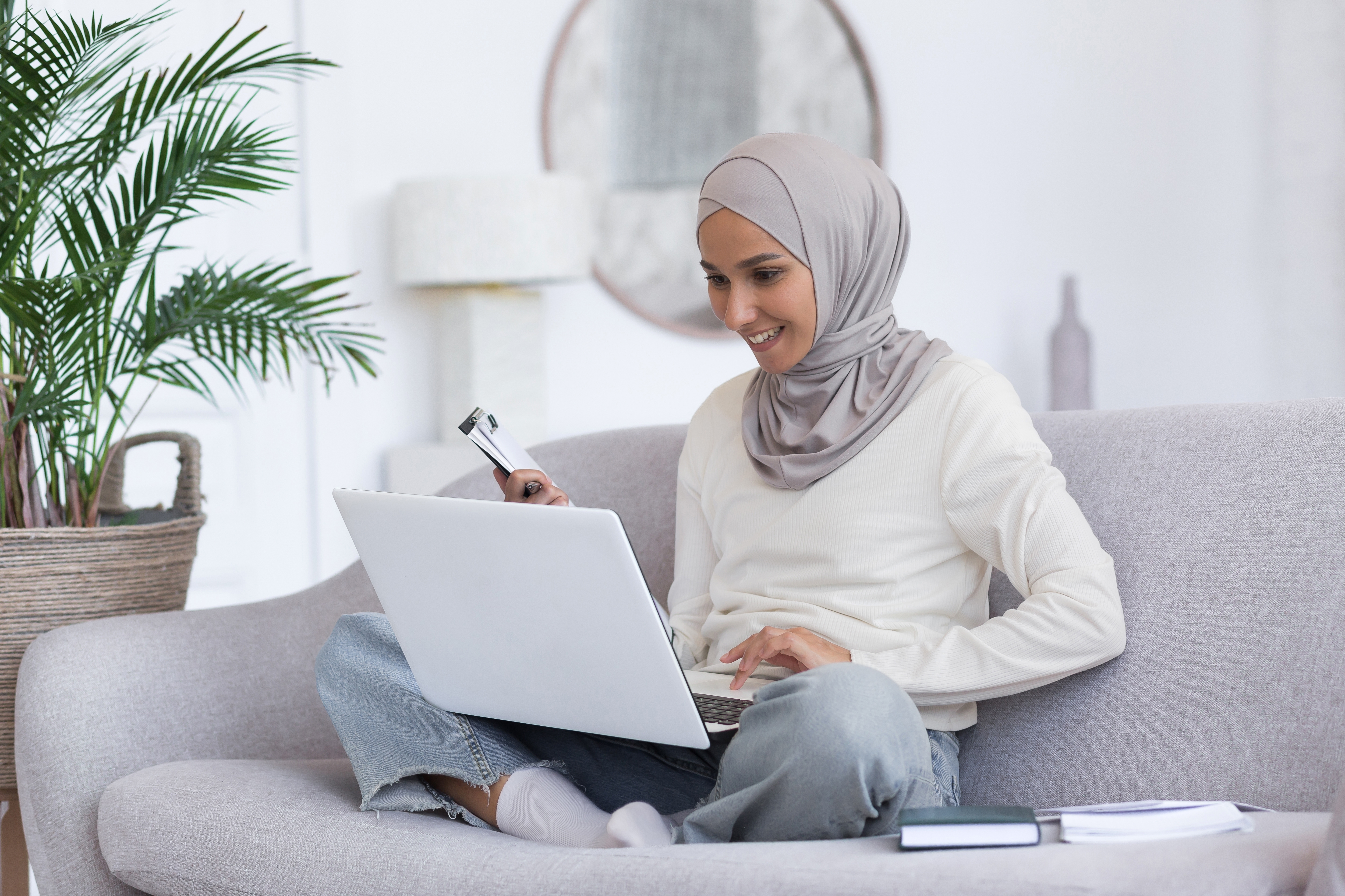 Woman sitting on her couch and exploring Berlitz Flex while smiling