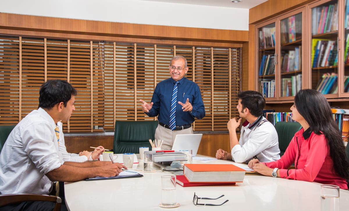 Director talking to his international team in English with confidence after attending professional training with Berlitz Canada