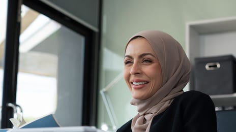 Woman with a laptop using Berlitz Connect to learn a new language for her government work