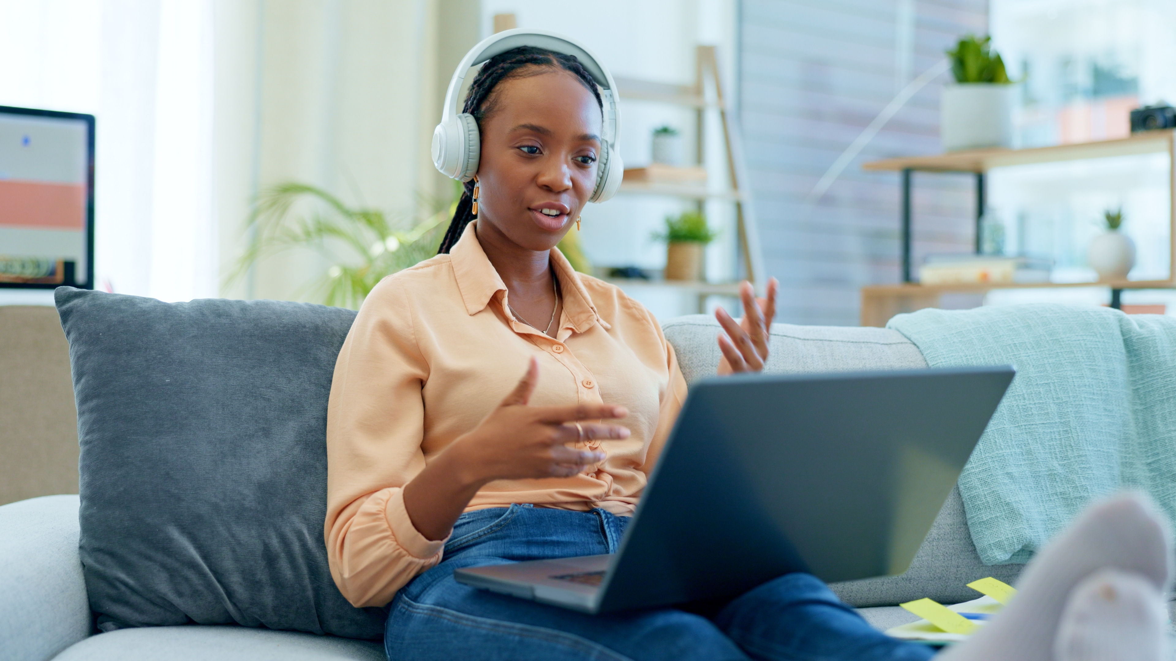 Woman with headphones talking to her instructor during an online TEF preparation course with Berlitz Edmonton
