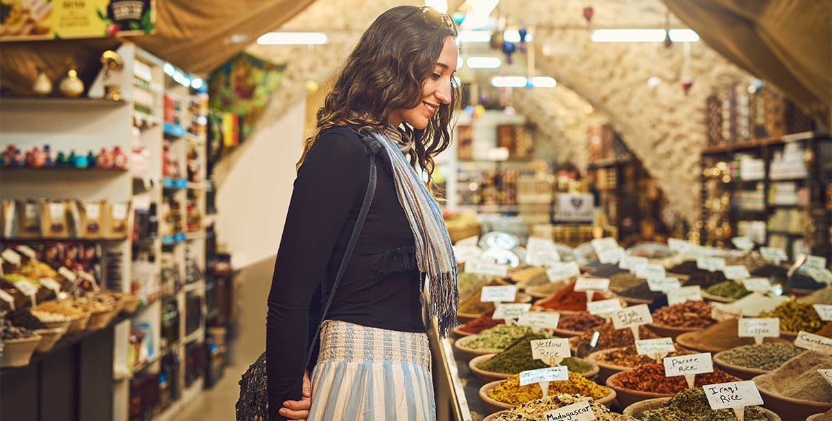 Woman checking the spices in a shop abroad