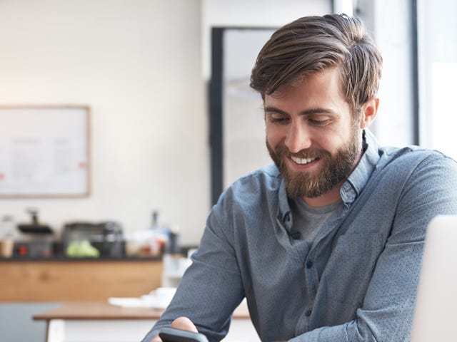 man attending his online language classes on his phone