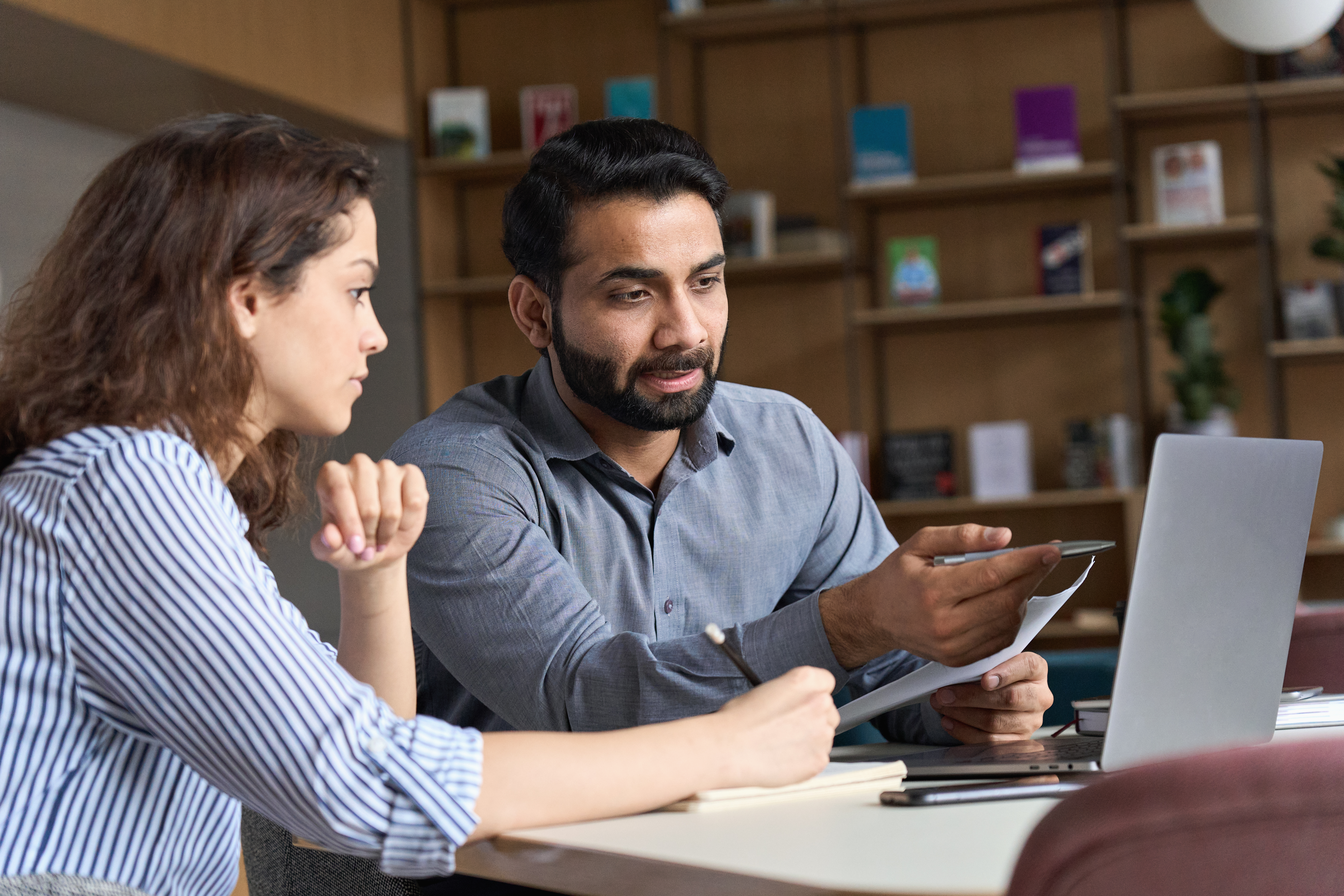 Instructor talking to his student about an exercise during a private language lesson with Berlitz Canada