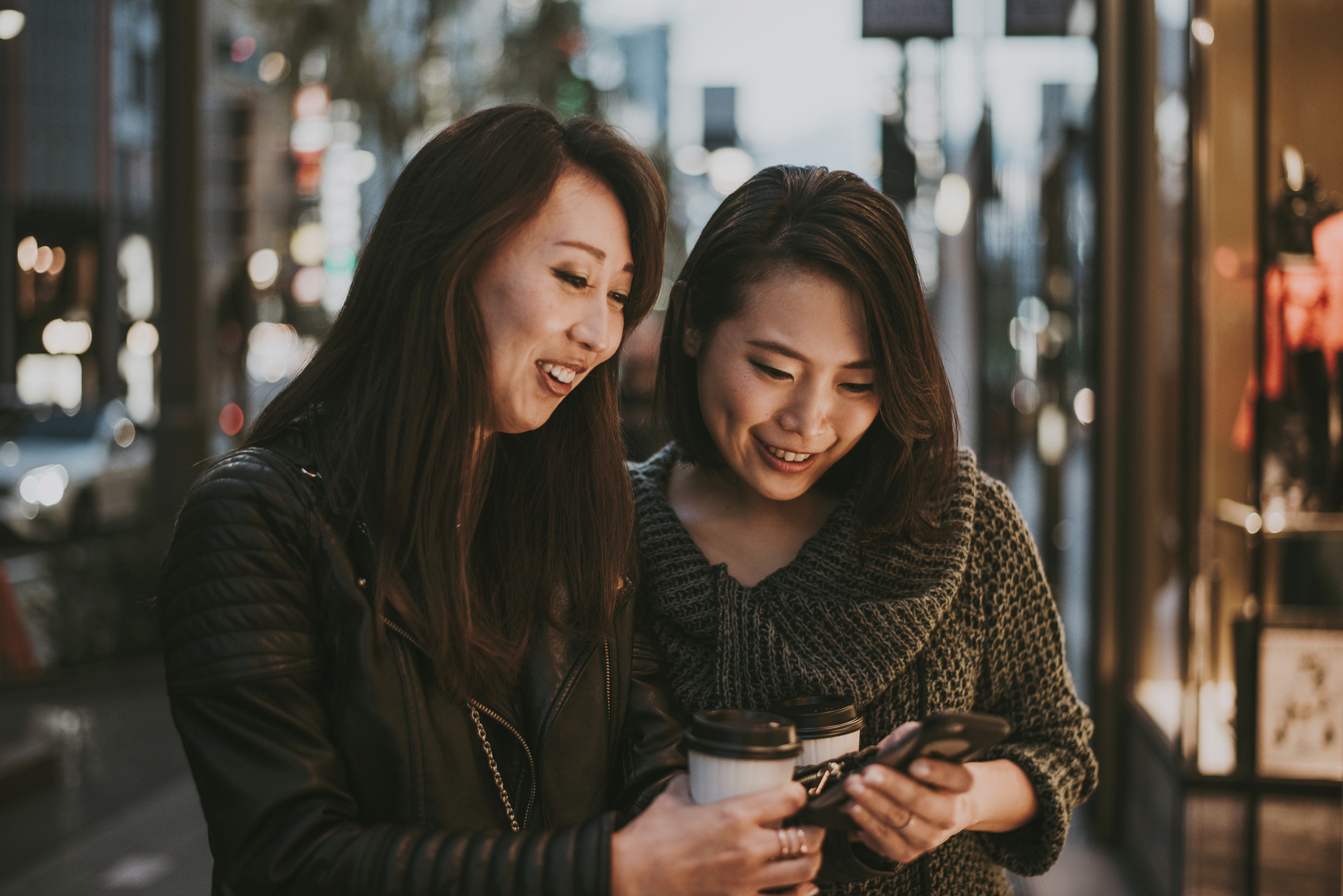 women learning arabic online from their phone