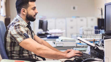 man learning french online in the office