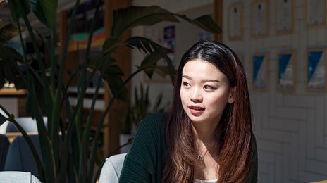 woman attending an online english class from a cafe