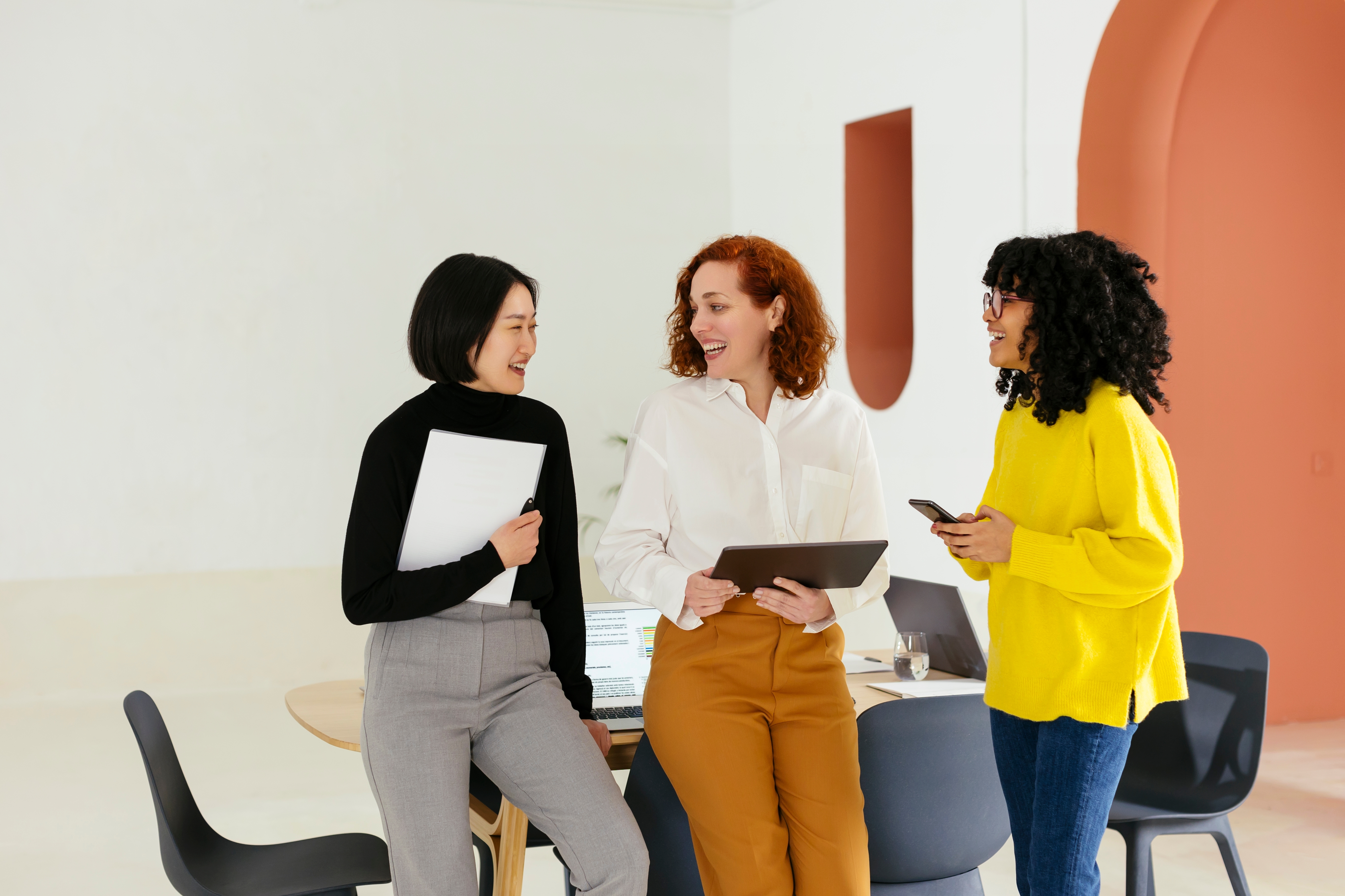 Women at their workplace chatting after their business French class with Berlitz Canada