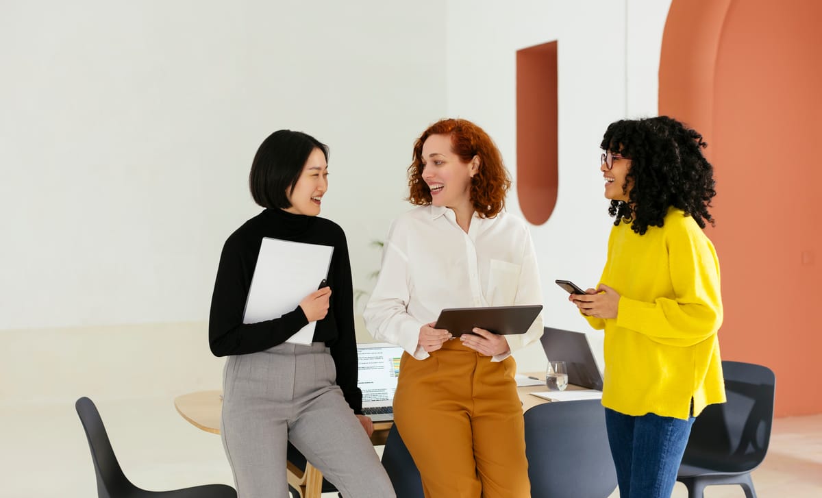 Women at their workplace chatting after their business French class with Berlitz Canada