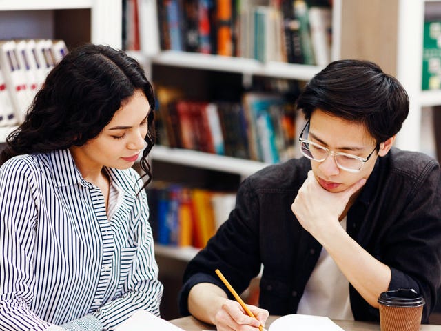 man and woman completing tasks during their in-person language classes