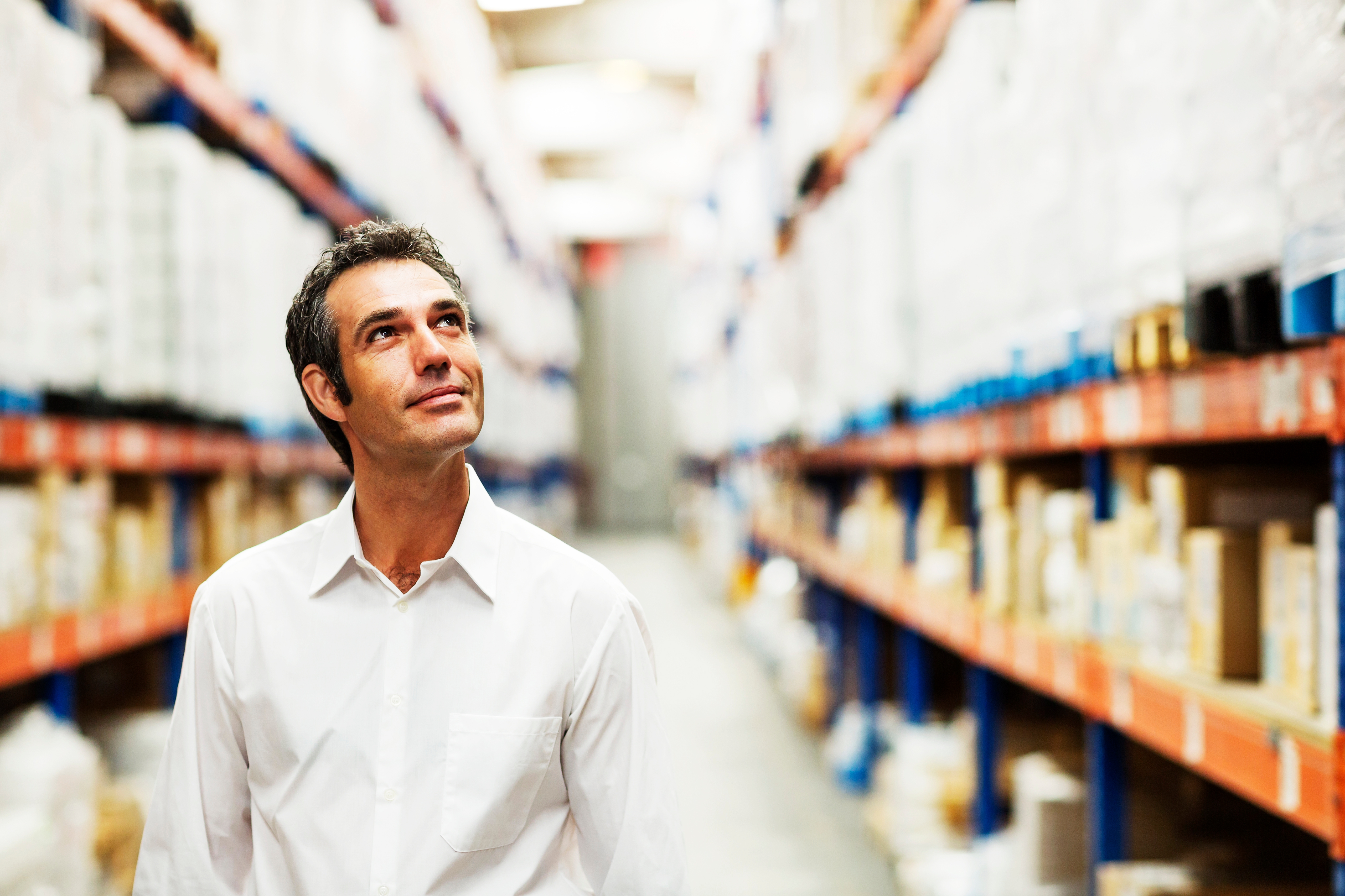 Man in a store looking up and smiling