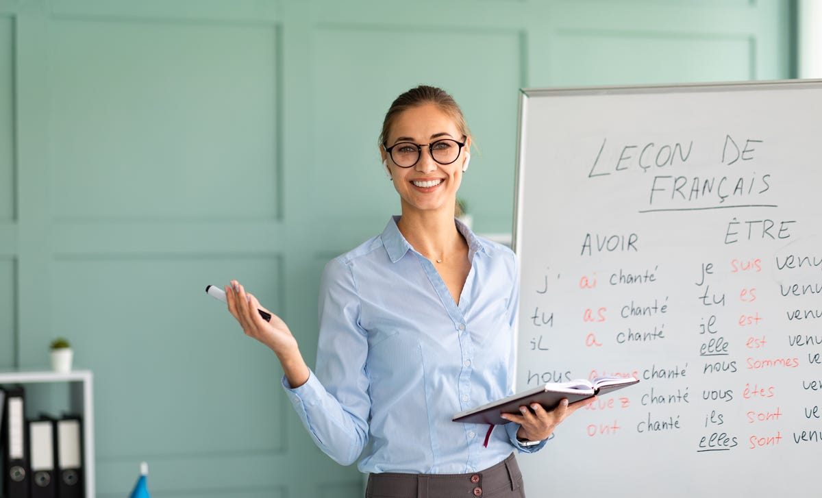 Berlitz instructor in front of a whiteboard during a French lesson in Victoria