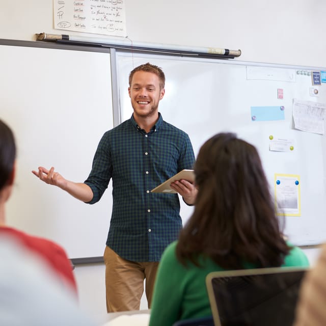 Student talking in French confidently in front of the class