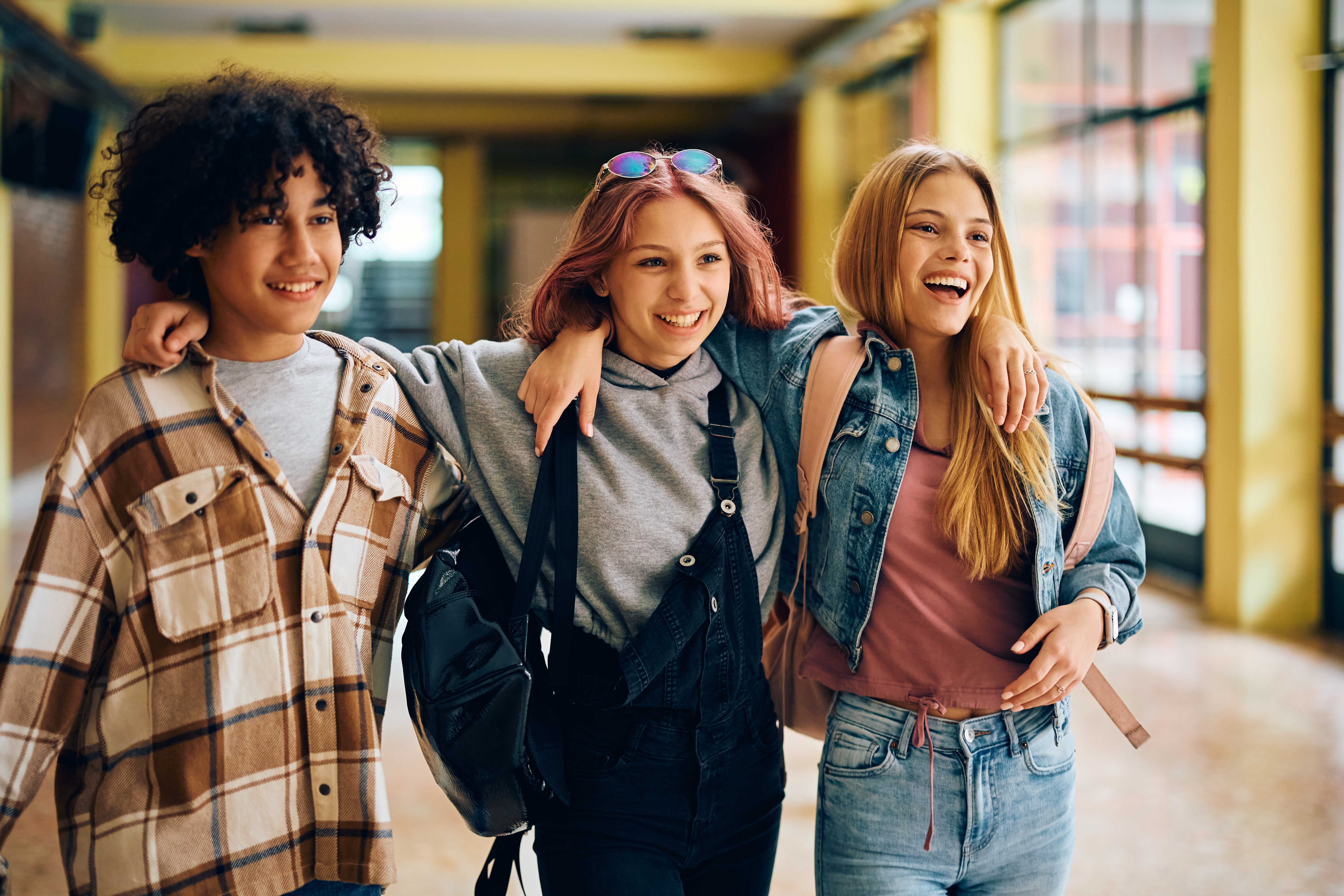 Group of teenagers hugging each other happily before their Spanish language lesson for kids and teens with Berlitz Canada