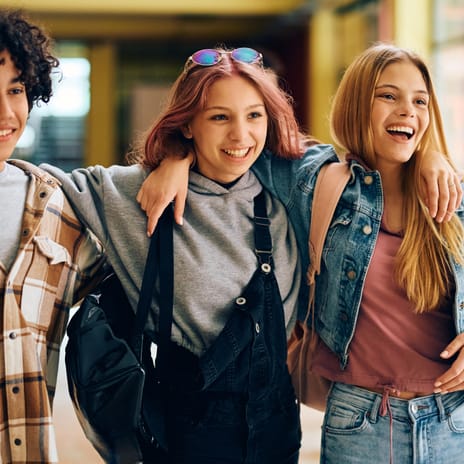 Group of teenagers hugging each other happily before their Spanish language lesson for kids and teens with Berlitz Canada