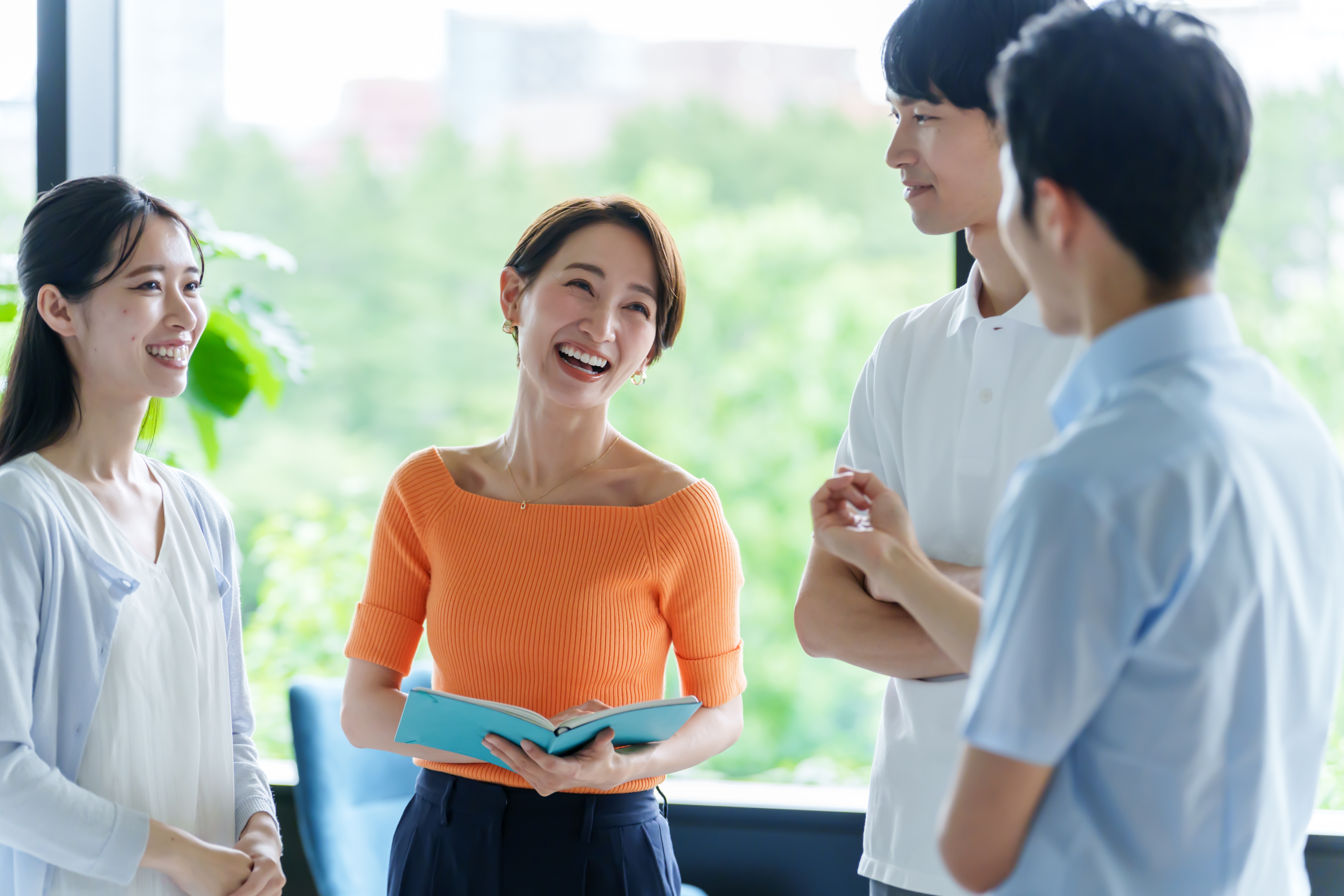 Coworkers chatting with each other happily after their government language training with Berlitz Canada