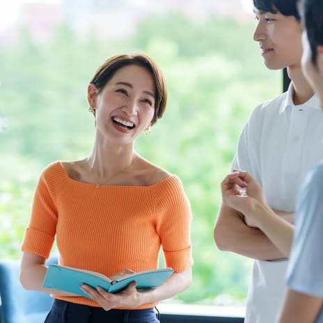 Coworkers chatting with each other happily after their government language training with Berlitz Canada