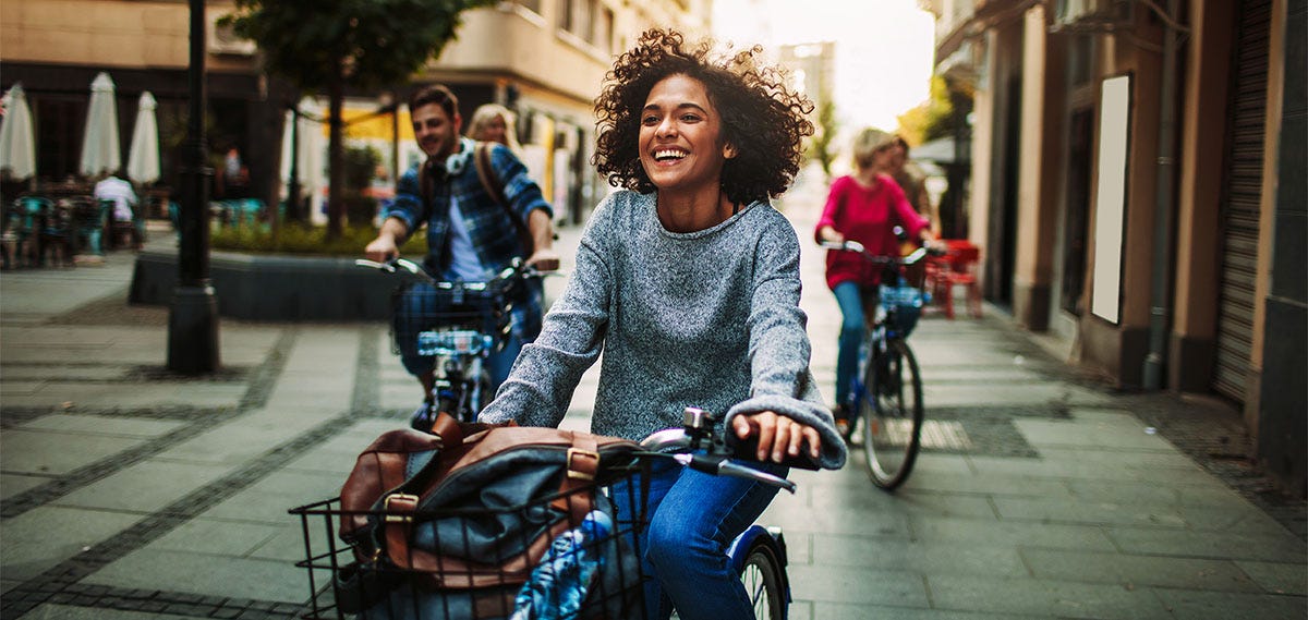Young woman cycling abroad during summer