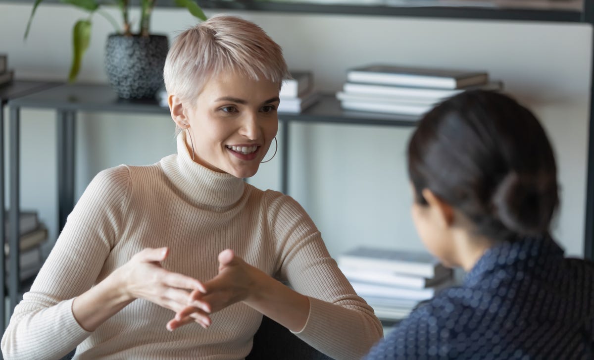 Woman talking to her instructor and smiling during a French class in Kelowna