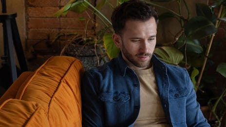 Man on the couch trying out Berlitz Flex and learning a new language from the comfort of his own home