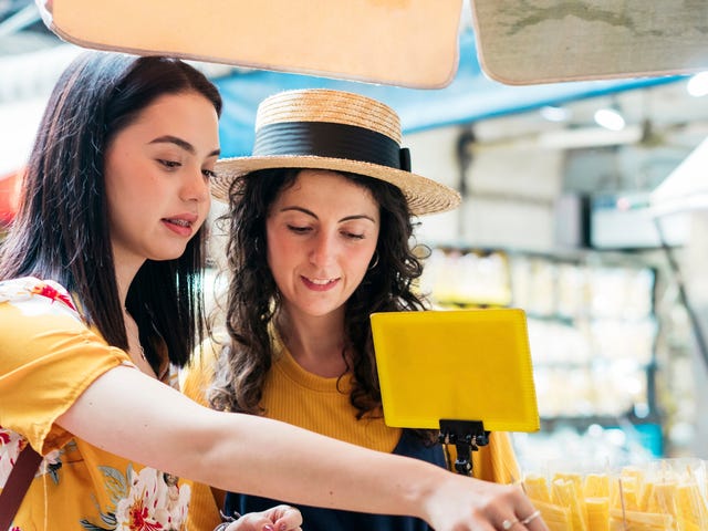 women buying gifts on their vacation abroad