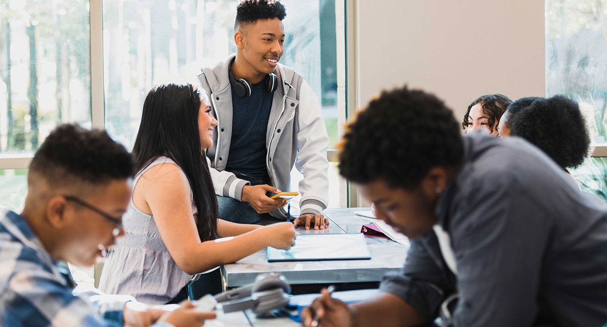 Students chatting in the classroom before their German lesson
