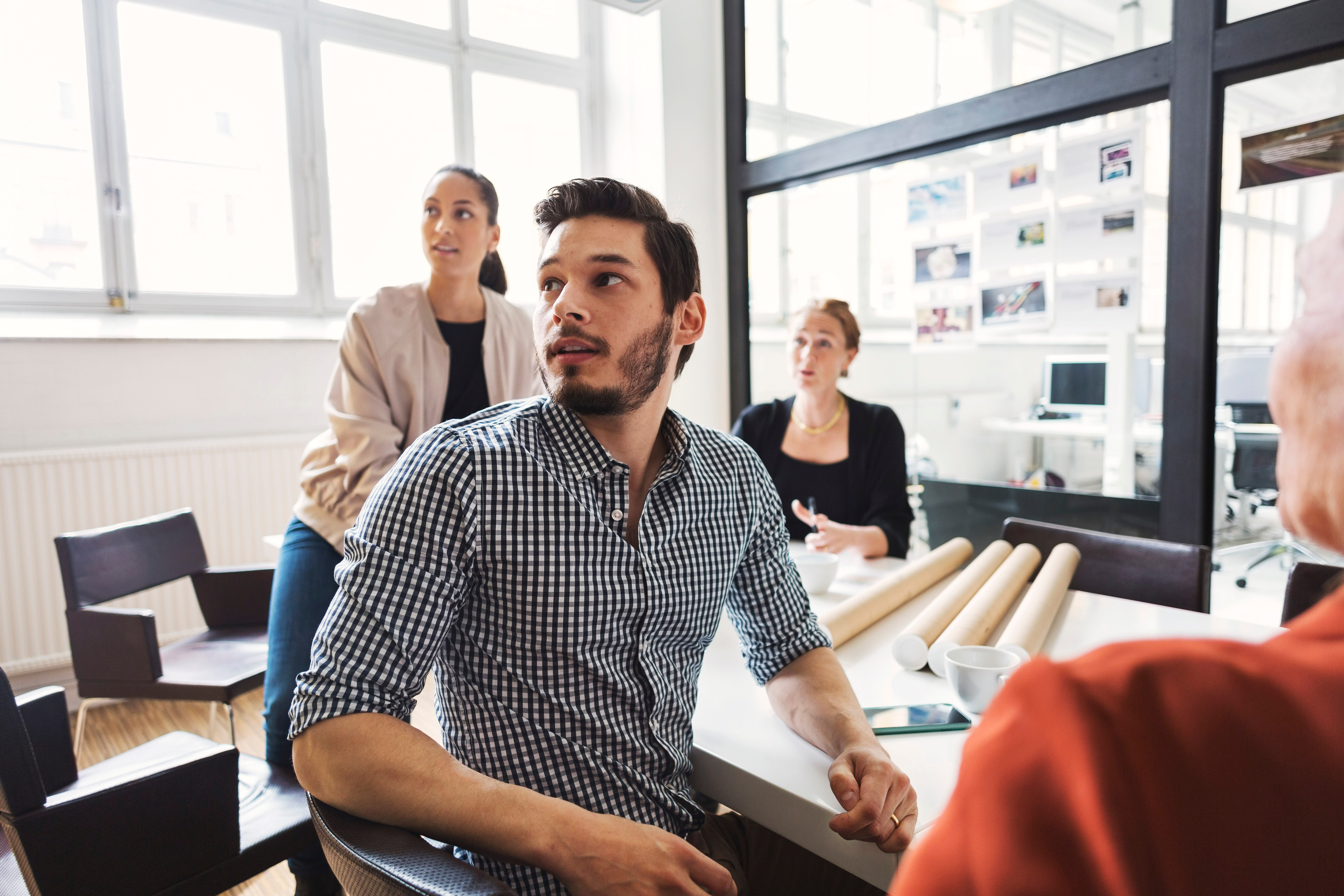 Man with his colleagues listening to their instructor during a government training with Berlitz Canada