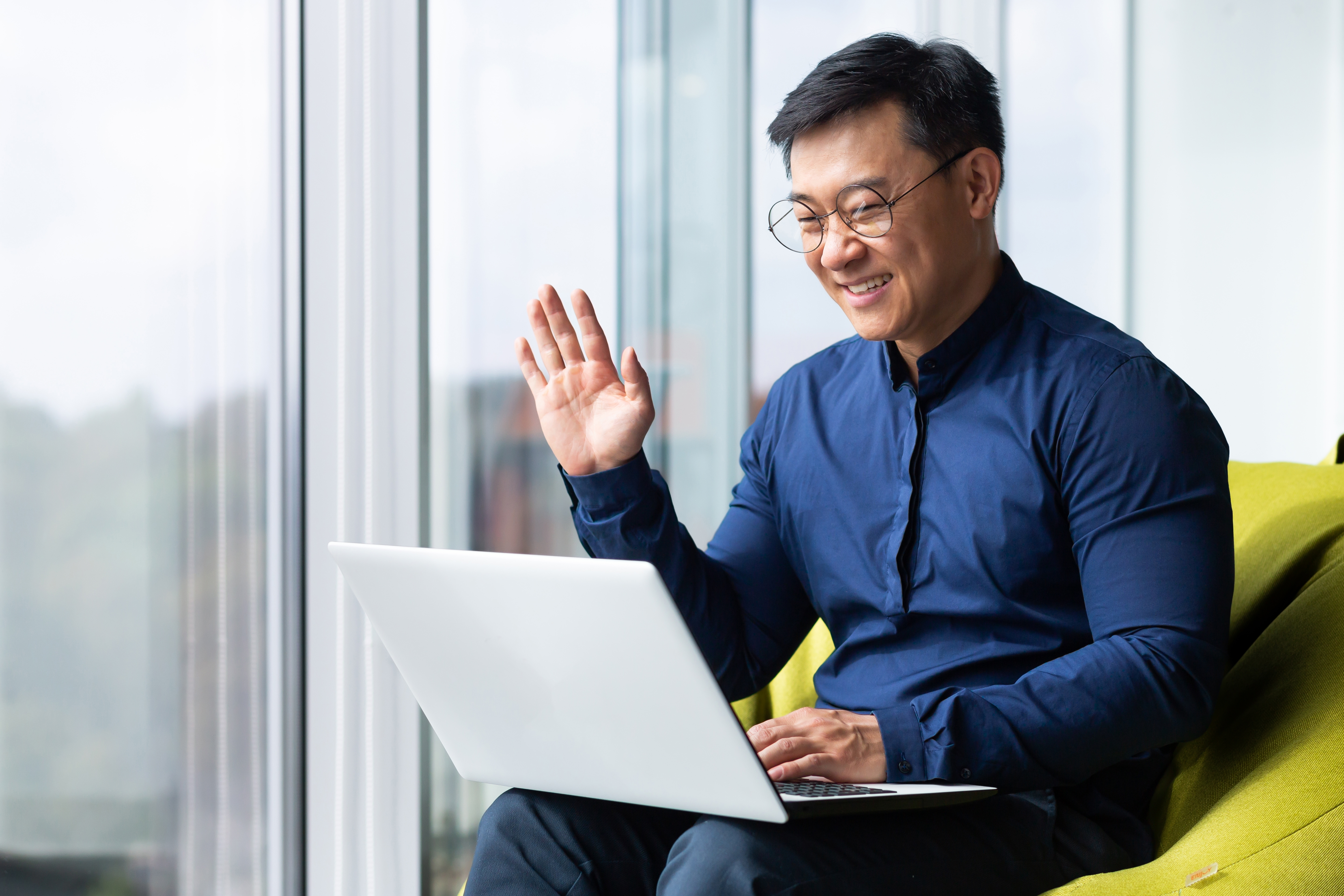 VP People & Culture greeting a teammate at an online meeting on his laptop after attending a Remote & Global Team Language Training with Berlitz Canada