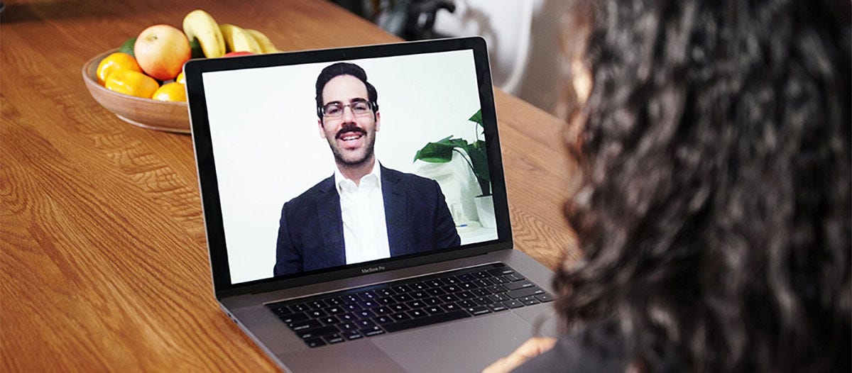 Man teaching an English class online from a laptop