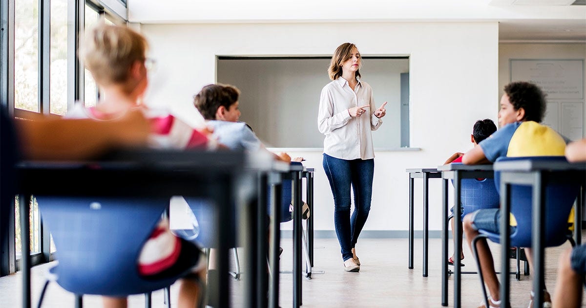 Woman is a classroom teaching English to kids abroad