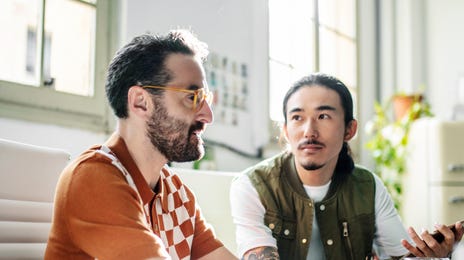 Men learning a language thanks to the Berlitz Method
