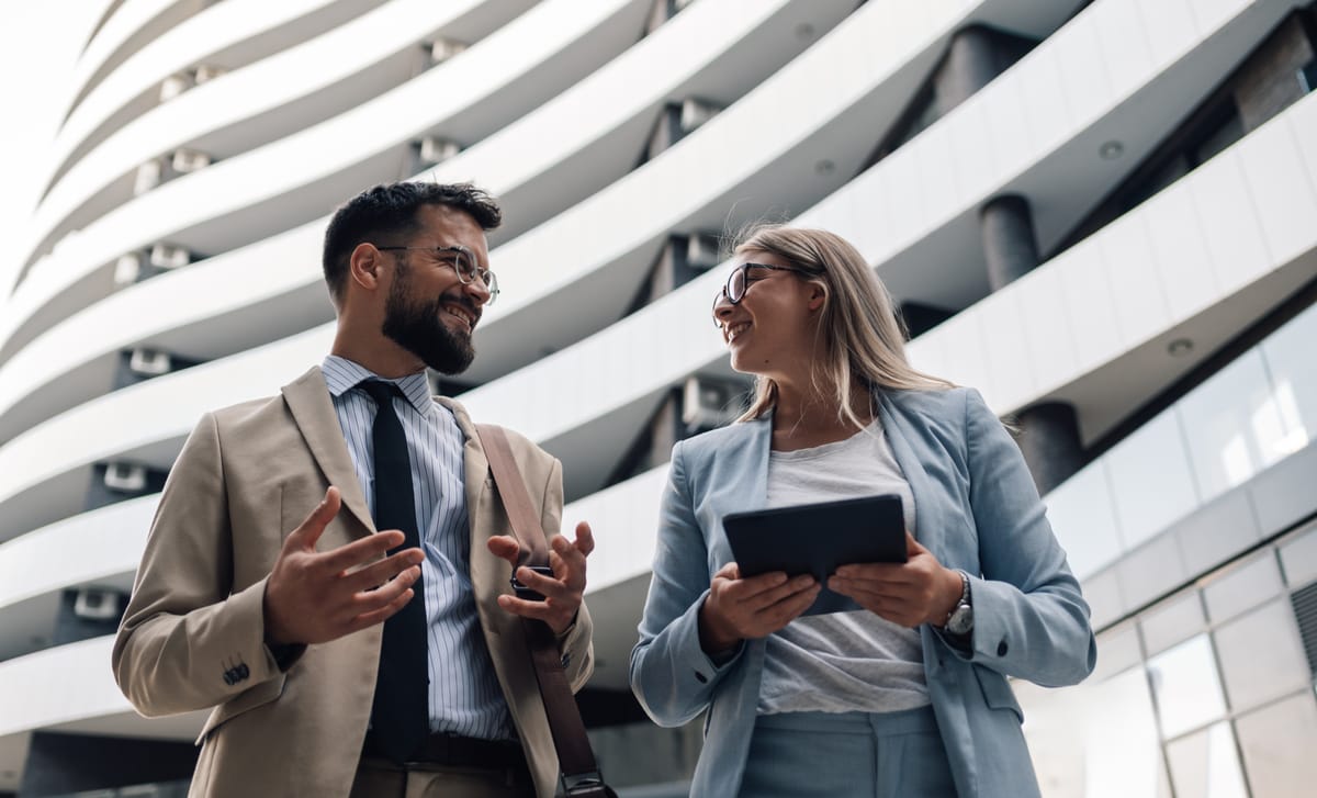 Coworkers chatting outside of a building before their Government Language Training with Berlitz Canada