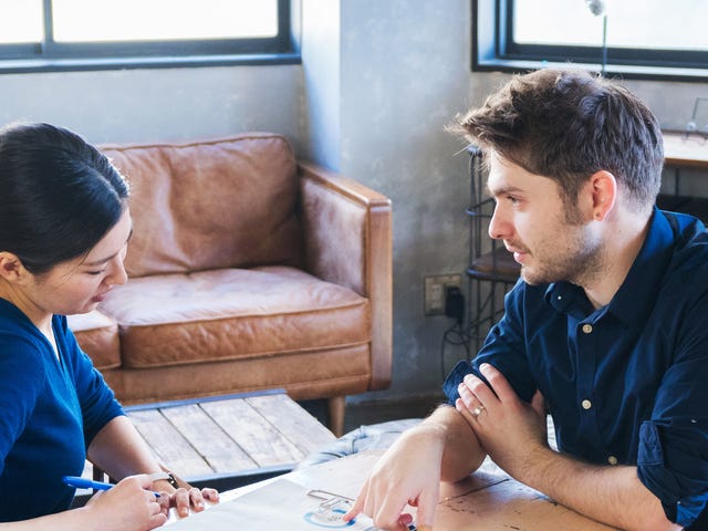 man and woman discussing homework for their private language classes
