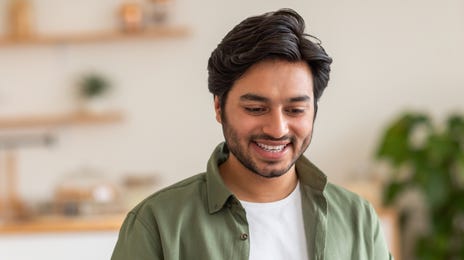 Man with a laptop attending an online intensive language class with Berlitz Canada