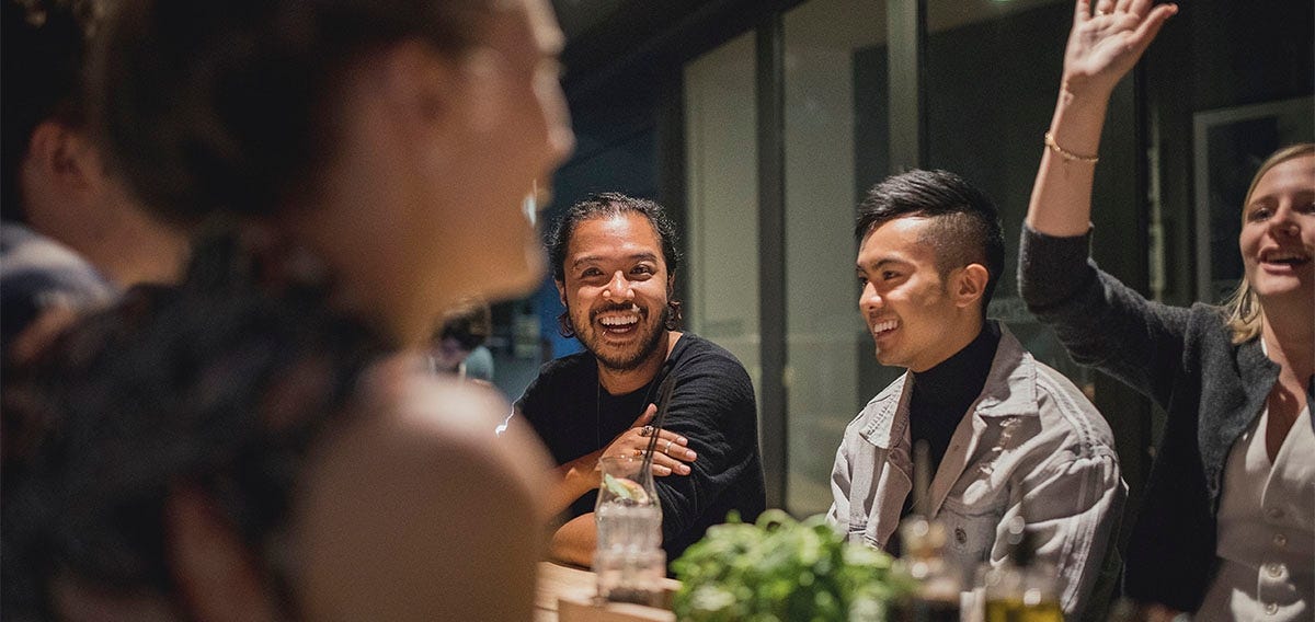 Friend group celebrating and eating dinner abroad