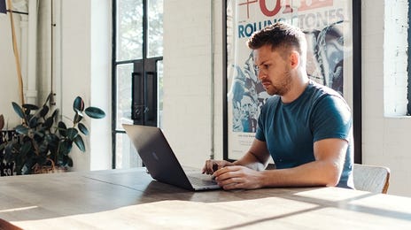 man attending an online english course on his laptop at home