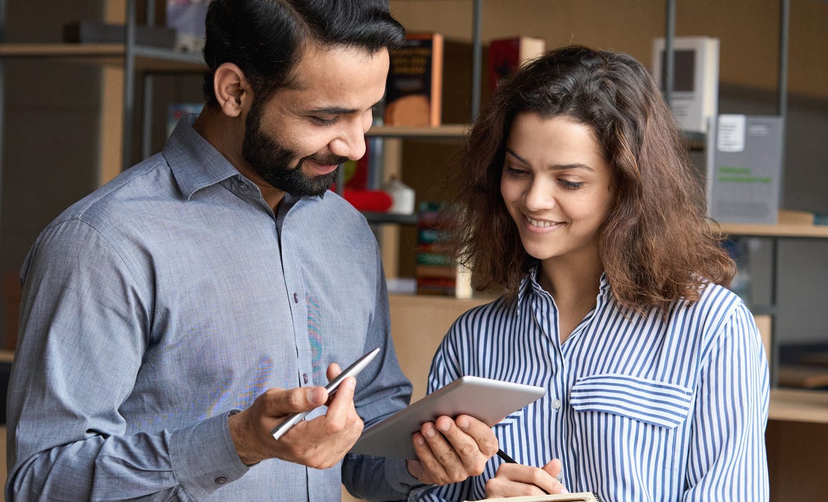 Instructor and student looking at a some notes during an English class in Edmonton with Berlitz