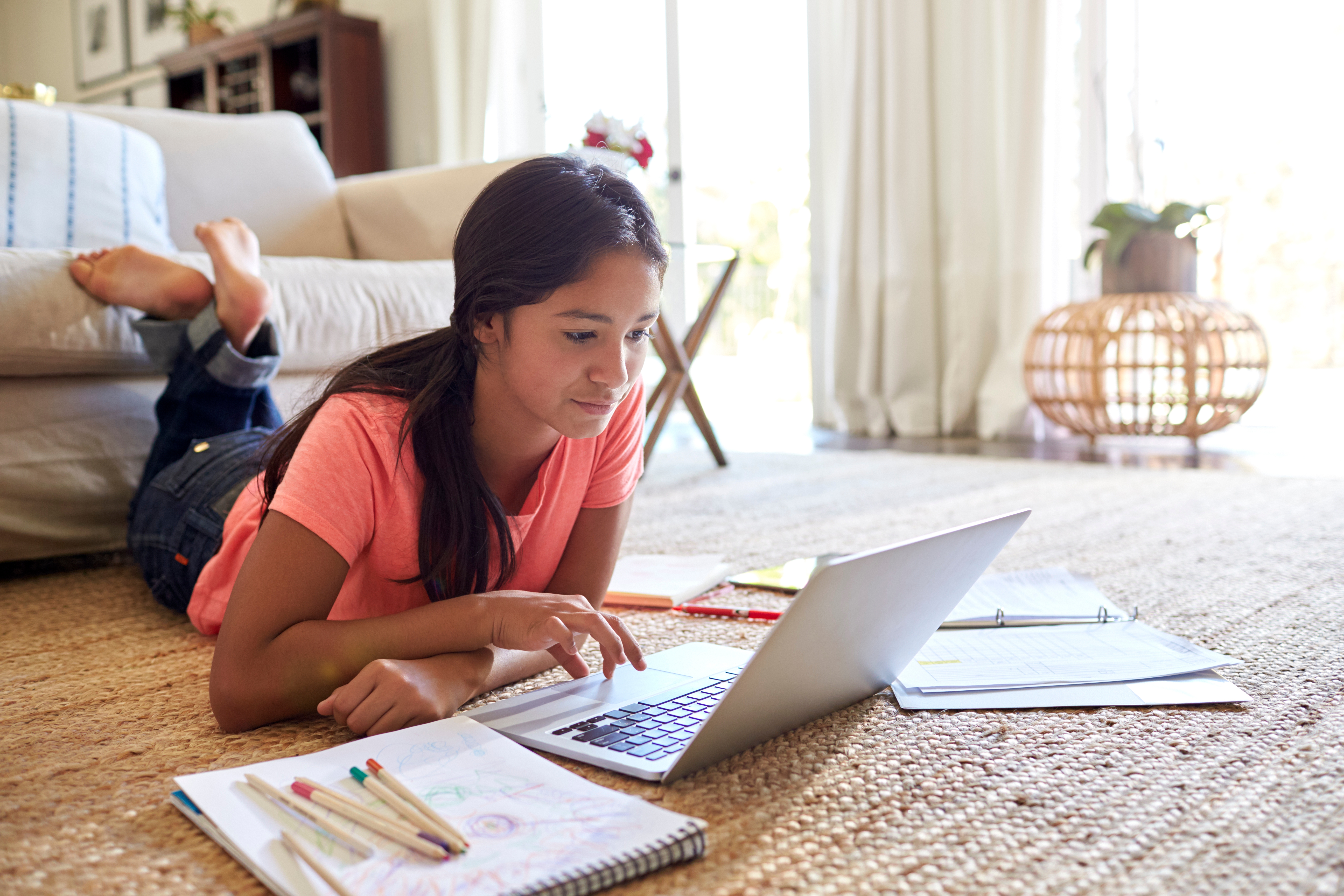 girl taking an online language course on her notebook
