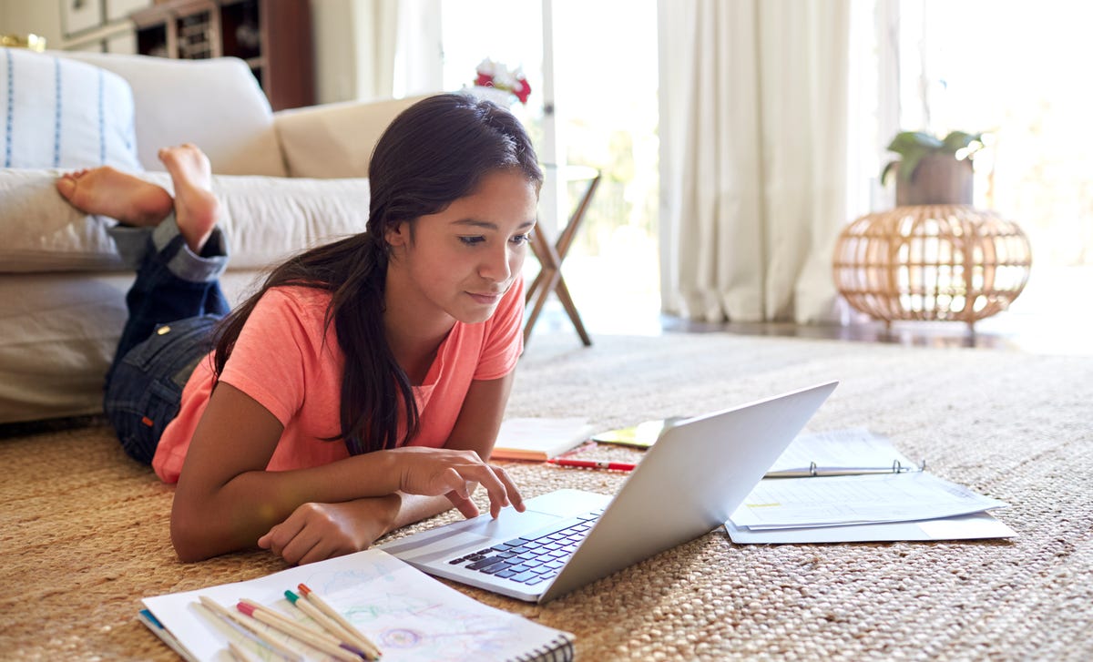 girl taking an online language course on her notebook
