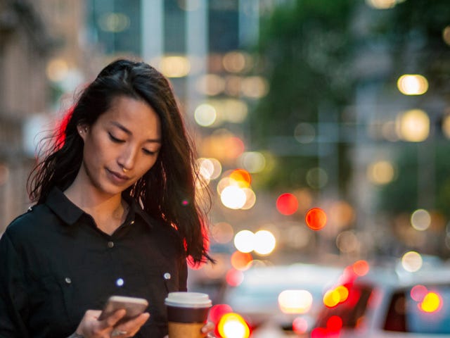 woman attending her self-paced studies online from her phone