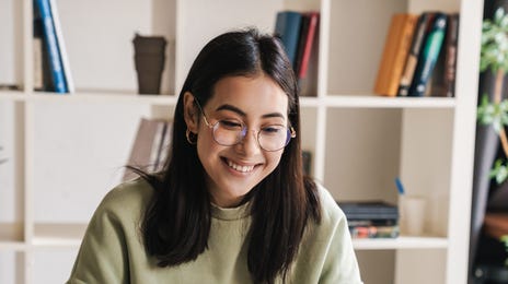Woman smiling at her instructor during her online language lesson with Berlitz Vaughan