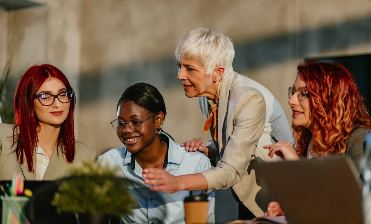 Instructor talking to her students while they are sitting at a table during a Spanish class in Toronto with Berlitz