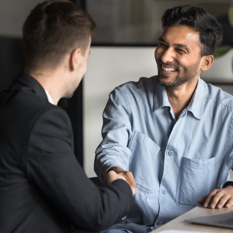 Instructor and student shaking hands before their first Spanish langauge lesson