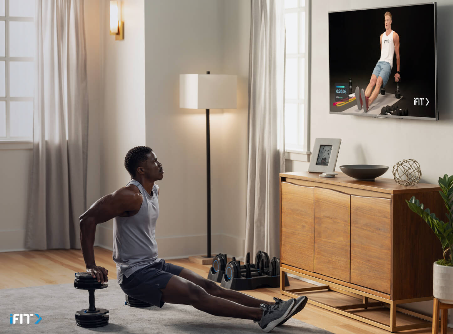 Man completes iFIT bodyweight exercises Man works out with iFIT bodyweight exercises