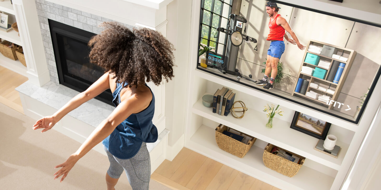 Woman does a cardio workout with the iFIT TV app Woman does a cardio workout using the iFIT TV app