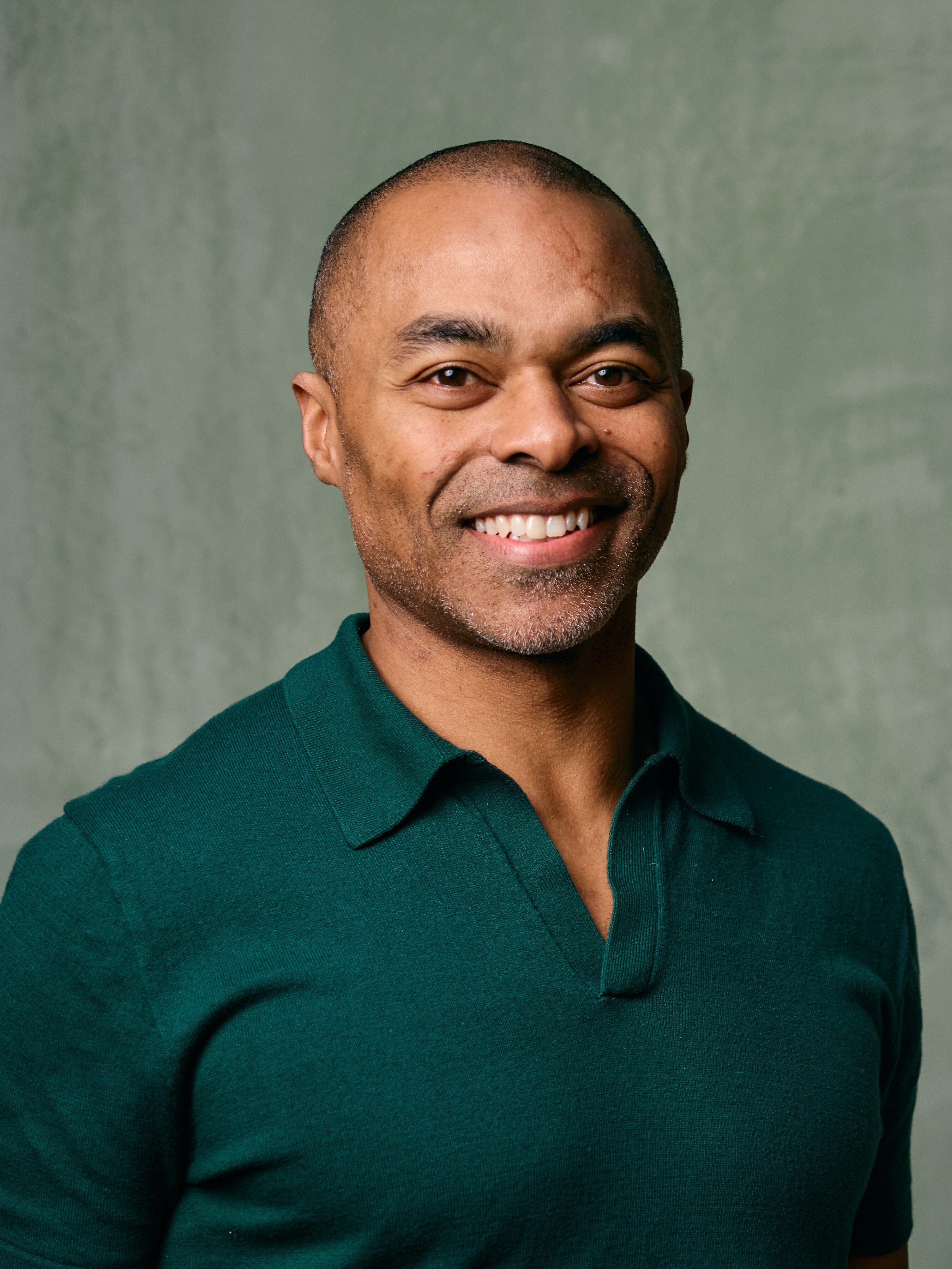 Marc Washington, President and Chief Financial Officer of iFIT, smiling in a green collared shirt against a neutral background.