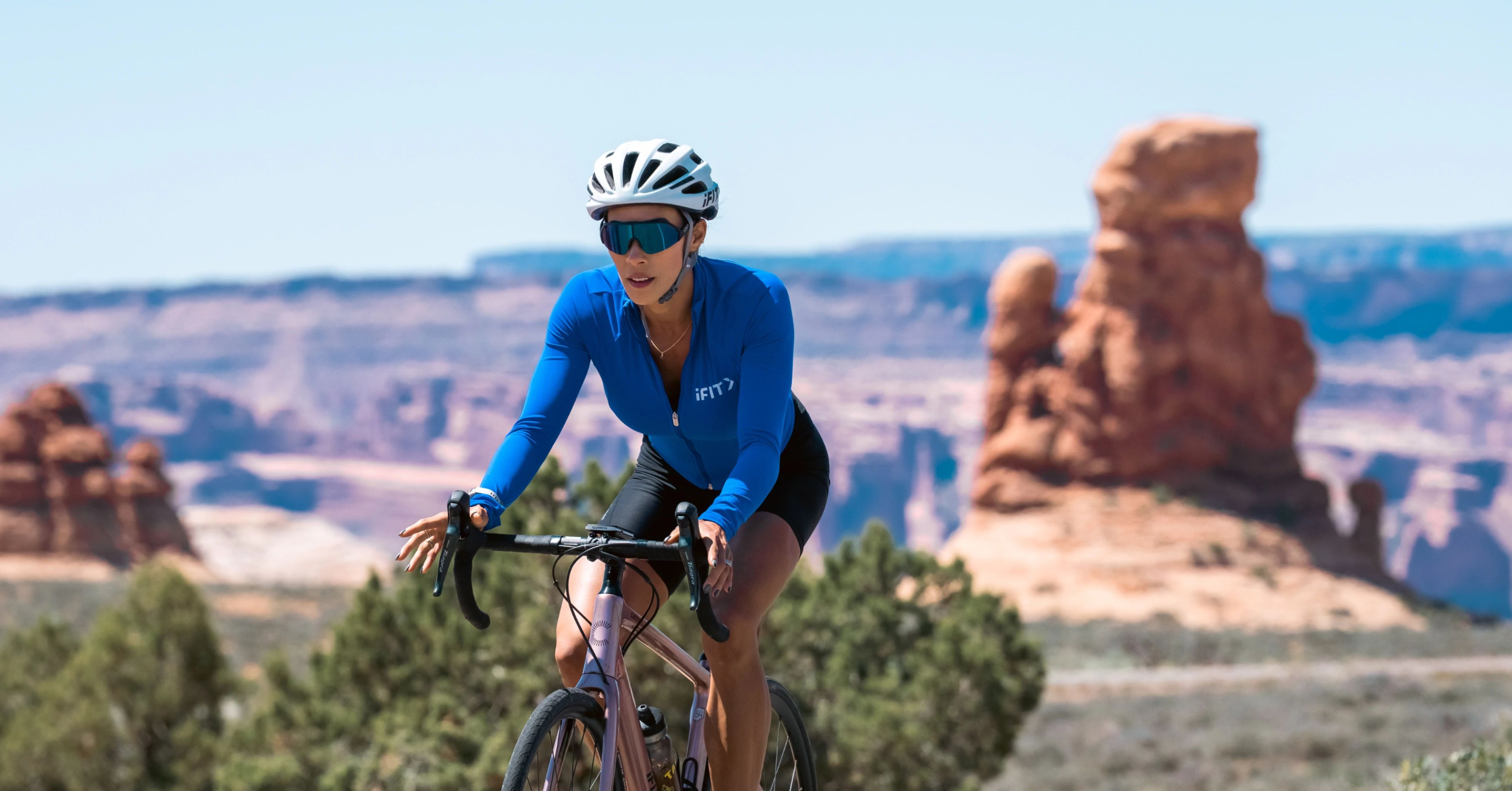 iFIT Trainer Hannah Eden rides through Arches National Park in Utah, guiding members through progressive cycling workouts that build endurance and power.