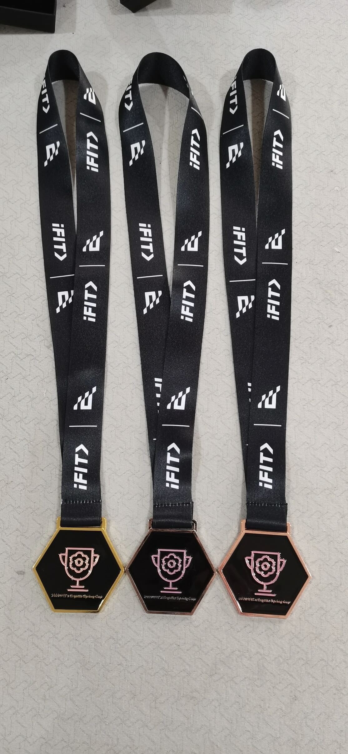 Official iFIT & Ergatta Spring Cup medals awarded to top performers across treadmill, bike, and row competitions.