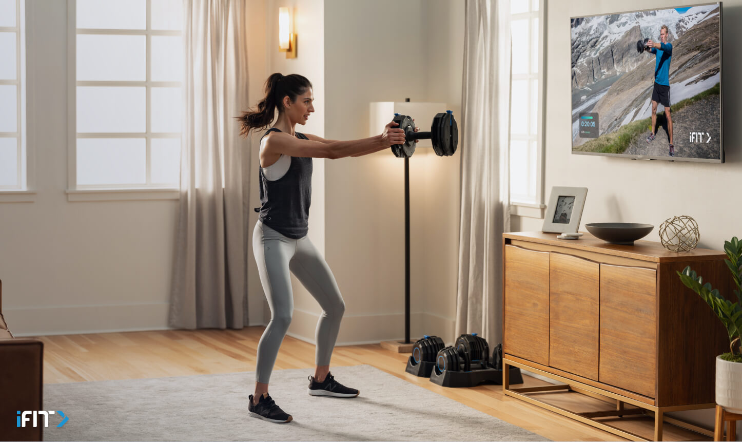 Woman completes an iFIT bootcamp class Woman completes an iFIT bootcamp exercise