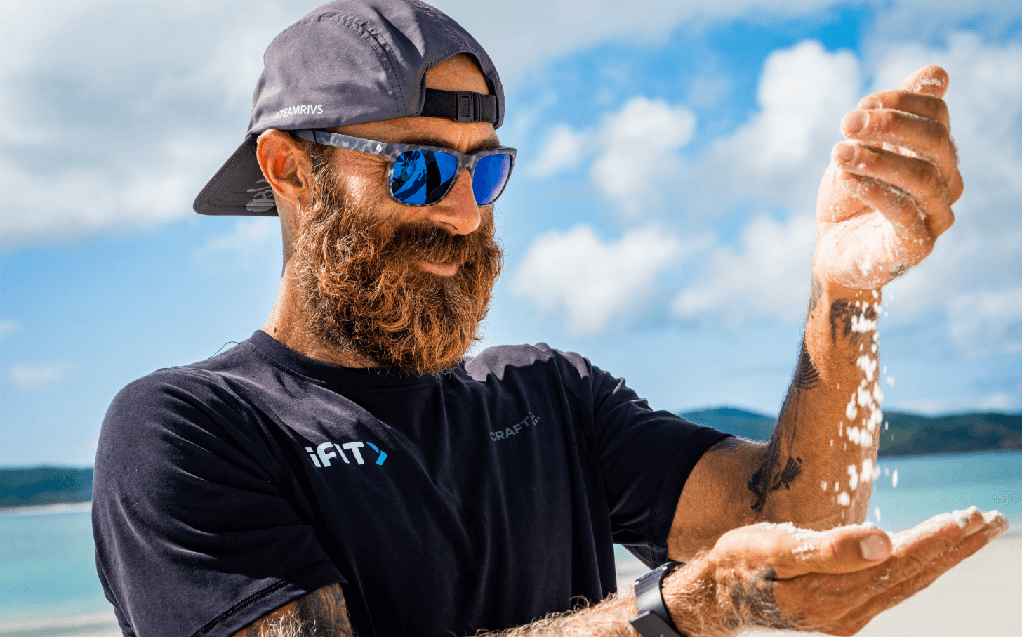 Tommy Rivs pours sand from one hand to the other.